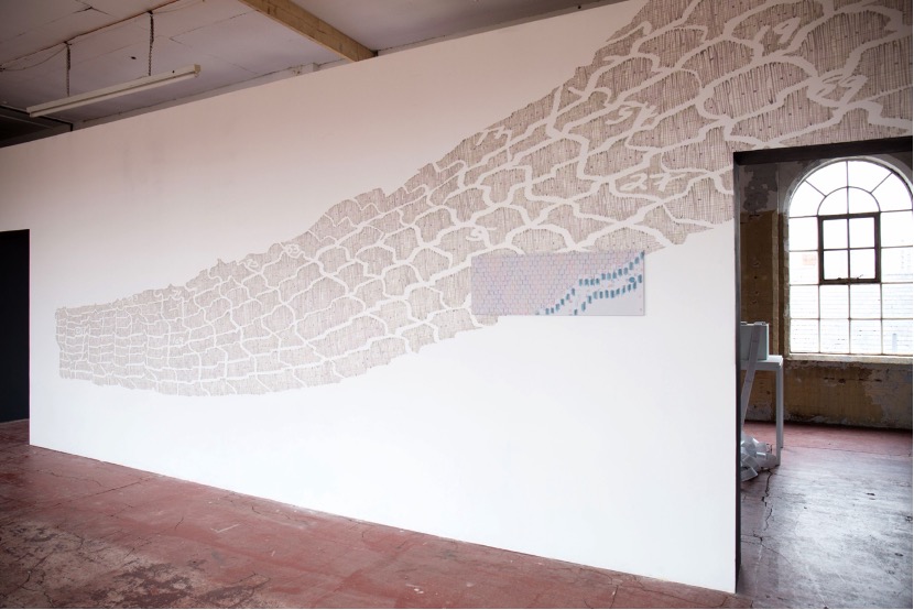 Figure 5. “Manhole”, 2018, 6.5 m x 3 m, emulsion wall paint with 34.5 cm x 100 cm pencil drawing on Mylar mounted on aluminium. During the exhibition “Bummock: The Lace Archive” at Backlit Gallery, Nottingham. Photo credit: Ellen Brady.