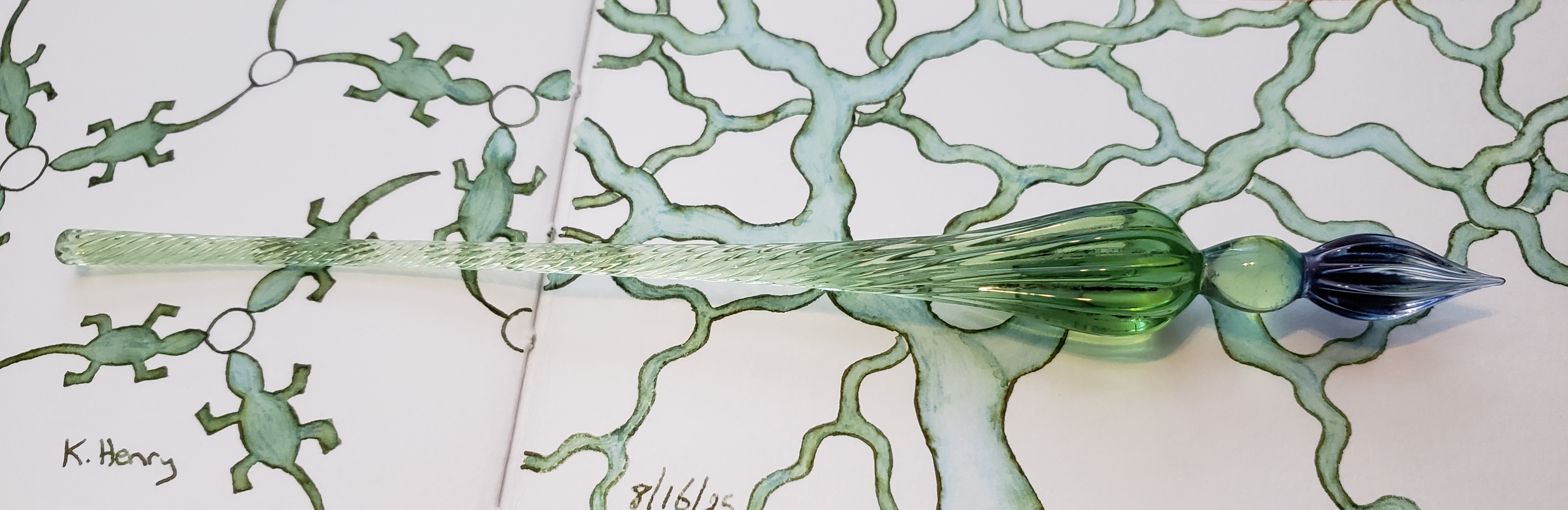 Figure 5: My glass dipping pen, sitting on my open sketchbook.*