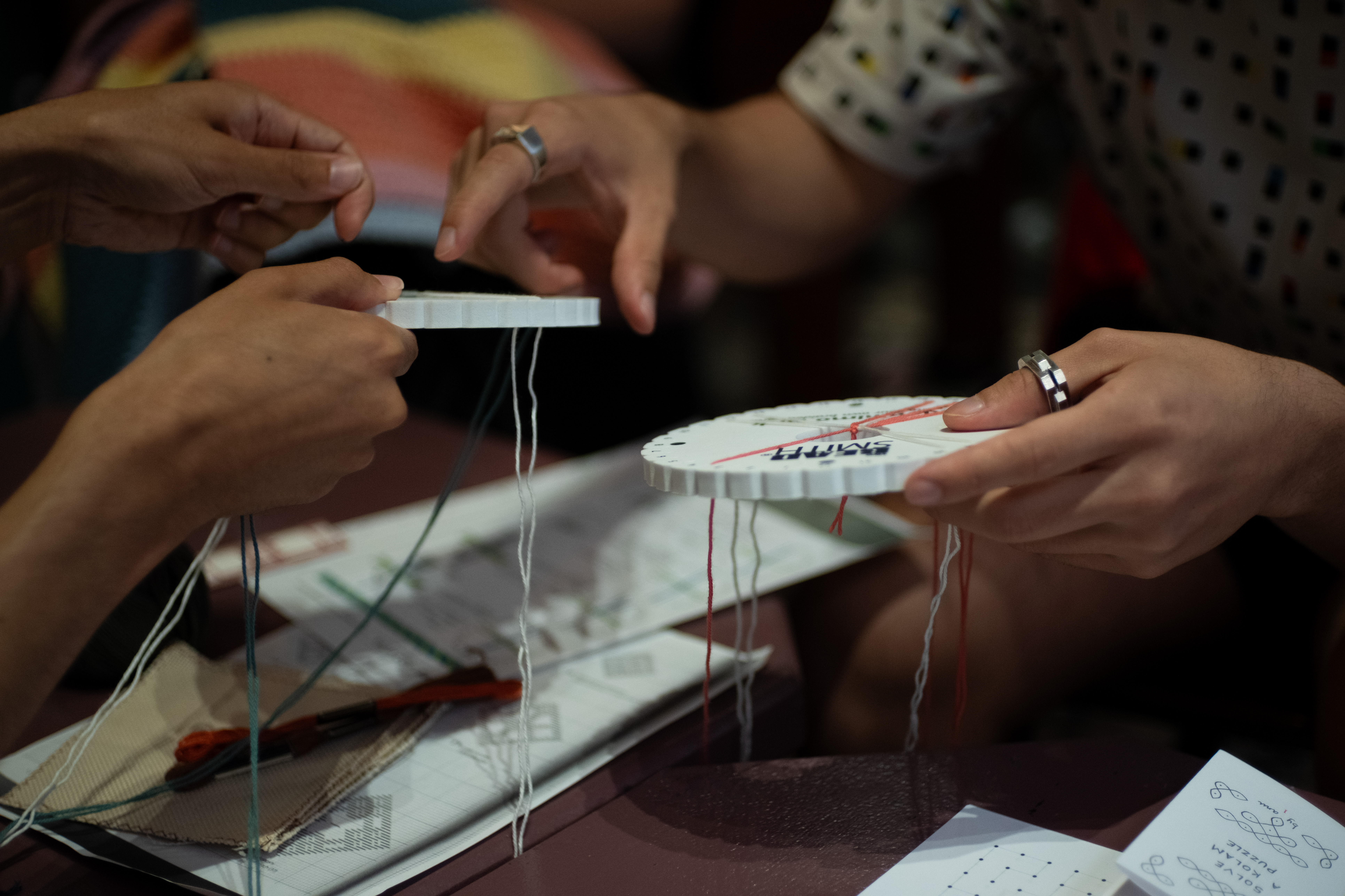 Figure 1: Making braided cords using kumihimo disks, The Glitch, August 2024. Photographer: Ava Majumdar.